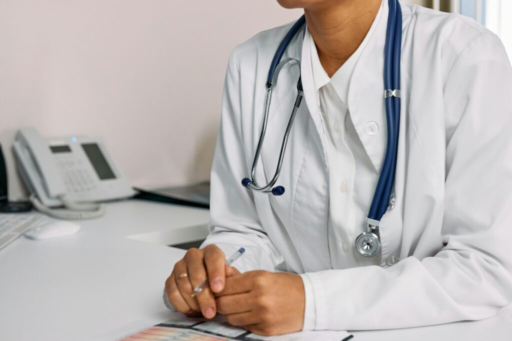 pexels-photo-7578800-7578800 A Woman in White Coat Sitting at the table